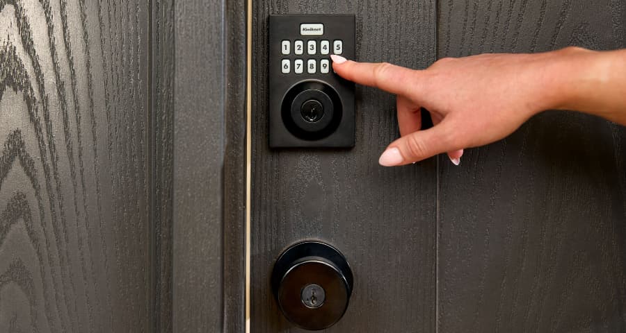 Homeowner touching the keypad of a Vivint smart lock